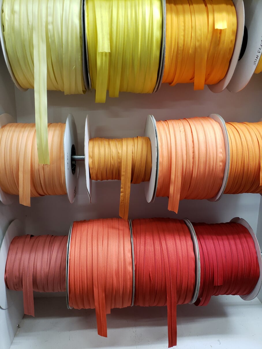 Zippers by the yard on huge spools.